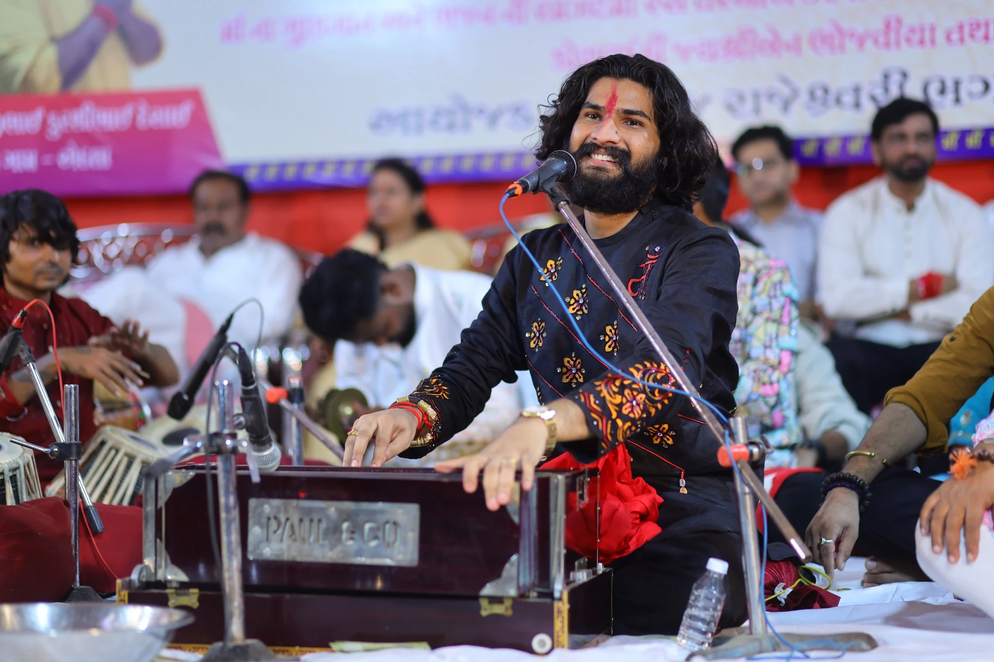 Nirav Barot performing with a harmonium