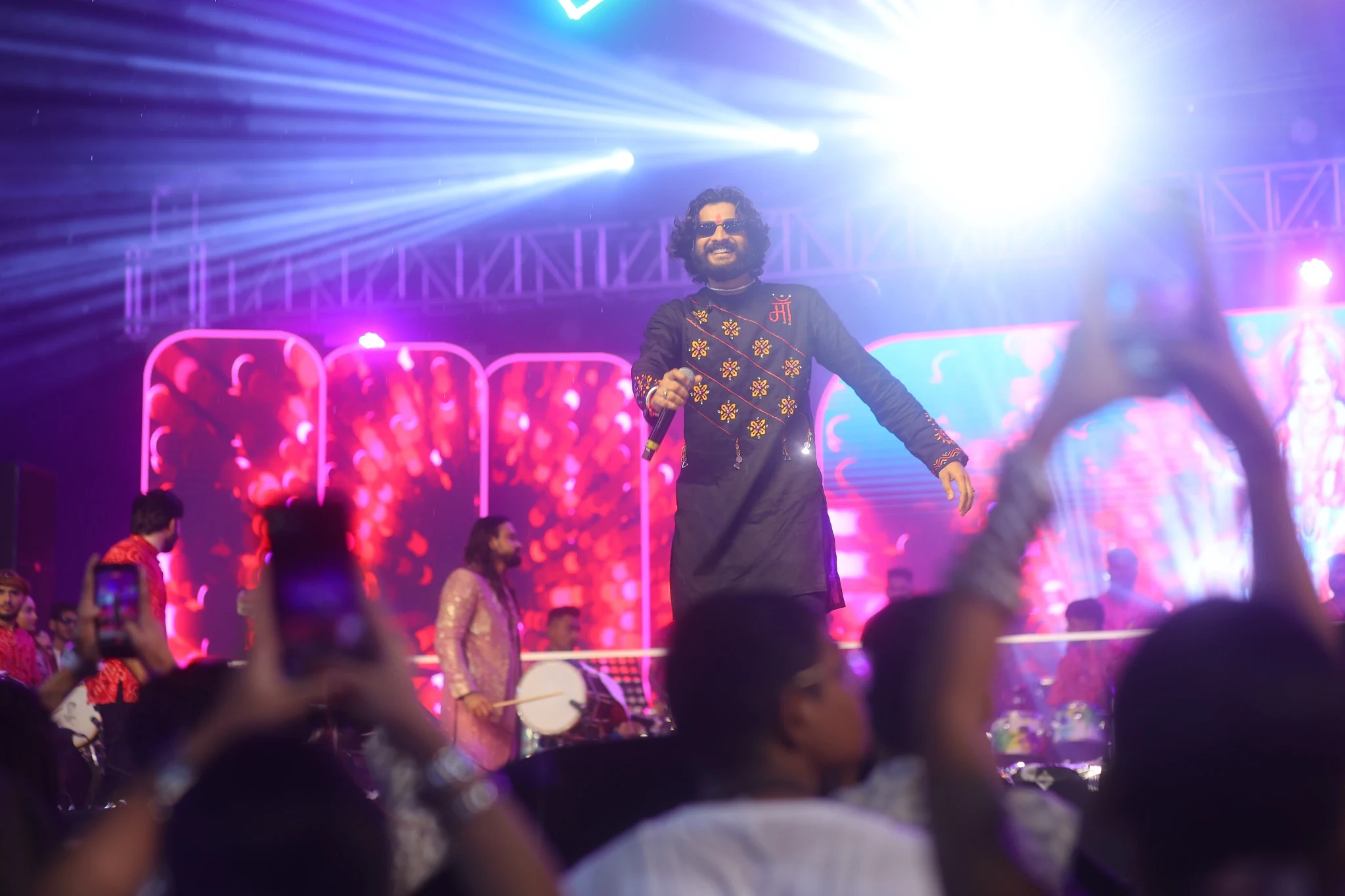 Nirav Barot walking across a concert stage